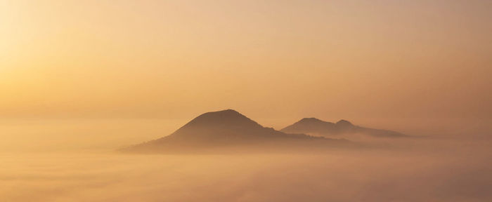 Scenic view of silhouette mountains against sky during sunset