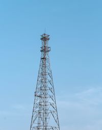 Low angle view of communications tower against sky