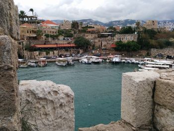 Boats in river with buildings in background