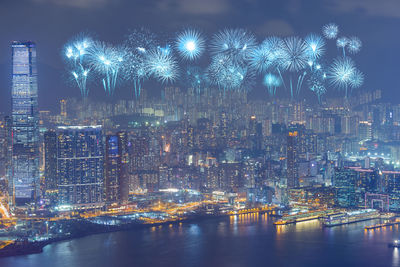 Firework display over river at night