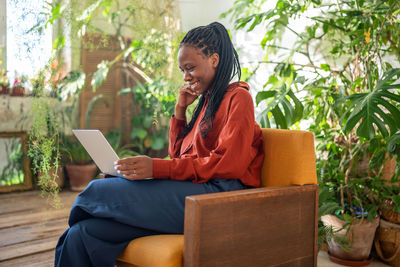 Young woman using laptop while sitting at home