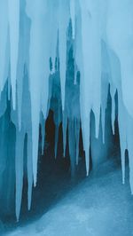 People standing by frozen lake during winter