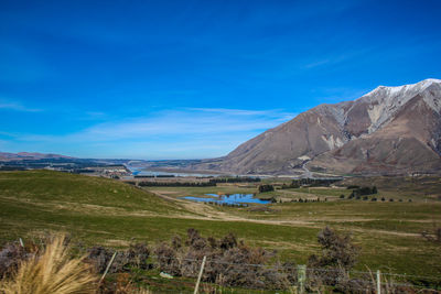 Scenic view of landscape against blue sky