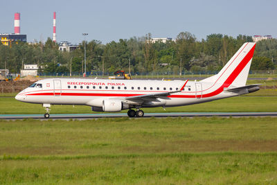 Airplane on runway against sky