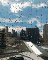 Raindrops on glass window in rainy season