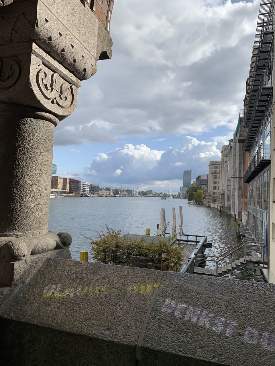 BUILDINGS BY RIVER IN CITY