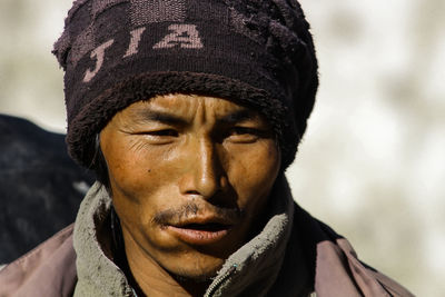 Close-up of man wearing knit hat