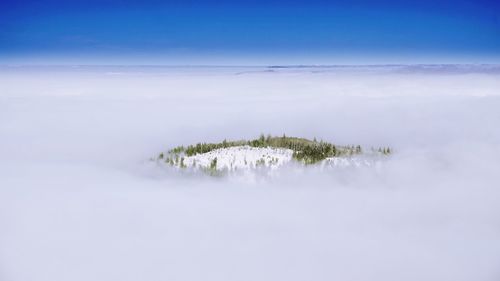 Scenic view of snow covered land against sky