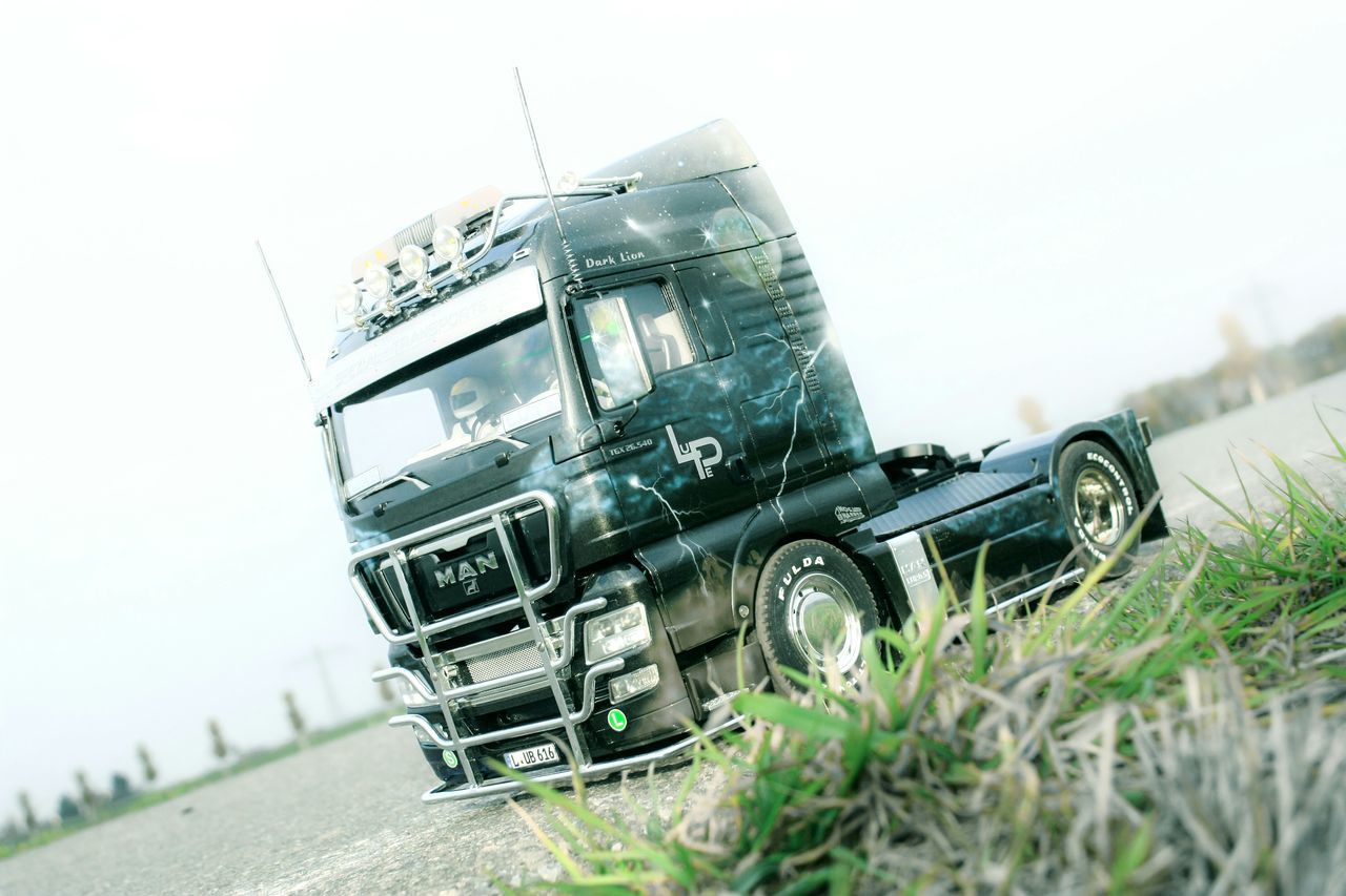 transportation, mode of transport, land vehicle, clear sky, car, abandoned, building exterior, built structure, architecture, day, obsolete, outdoors, no people, stationary, damaged, low angle view, old-fashioned, construction site, machinery, sky