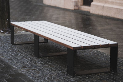 Empty bench on wet table during rainy season