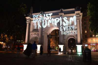 People walking in illuminated building at night