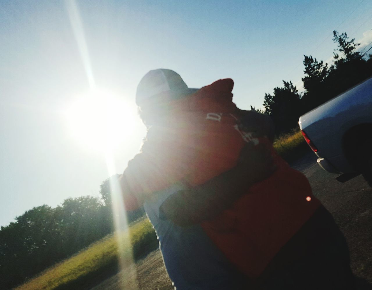 sun, sunbeam, lens flare, sunlight, low angle view, sky, sunny, bright, clear sky, statue, sculpture, day, human representation, tree, back lit, leisure activity, outdoors, brightly lit