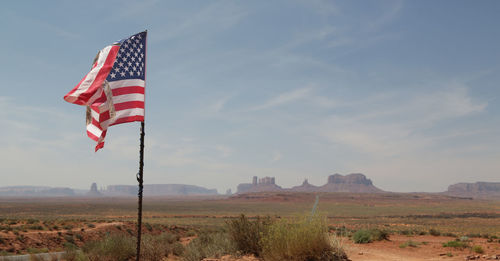 Flag on field against sky