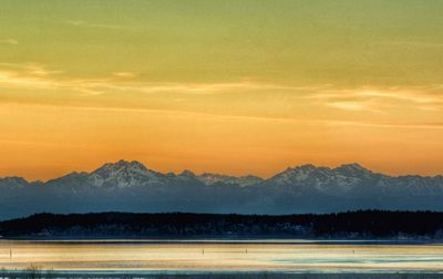 Scenic view of silhouette mountains against sky during sunset