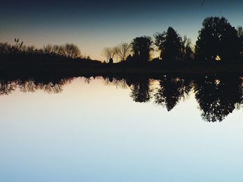 Scenic view of calm lake at sunset