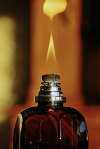 Close-up of burning oil lamp in glass bottle