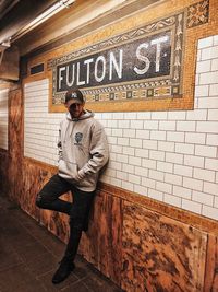 Man standing against wall