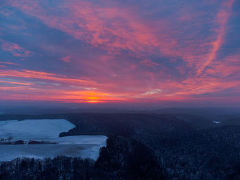 Scenic view of landscape against orange sky