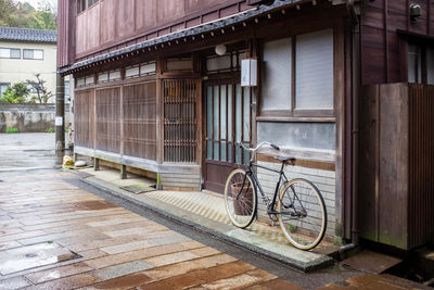 Bicycle parked on street by old building