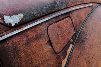 Close-up of old abandoned car gas tank lid