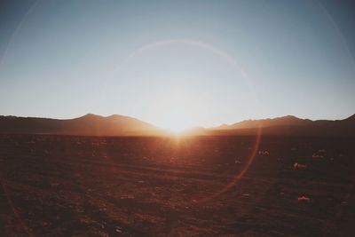 Scenic view of landscape against sky at sunset