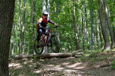 Man riding bicycle in forest