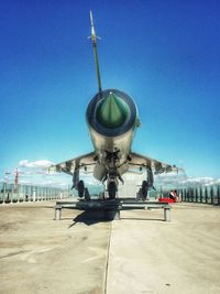 Military airplane against blue sky