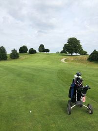 Golf course on field against sky