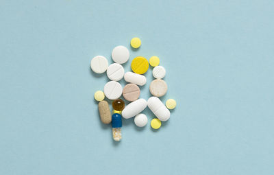 Directly above shot of pills against blue background