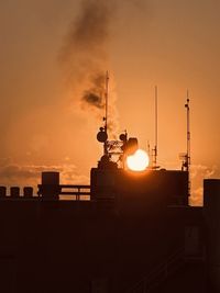 Low angle view of buildings against sky during sunset