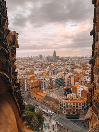 High angle view of cityscape against cloudy sky