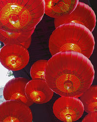 Low angle view of illuminated lanterns hanging from ceiling