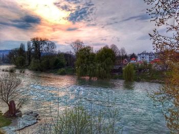 Scenic view of river against sky at sunset