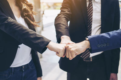 Midsection of couple holding hands