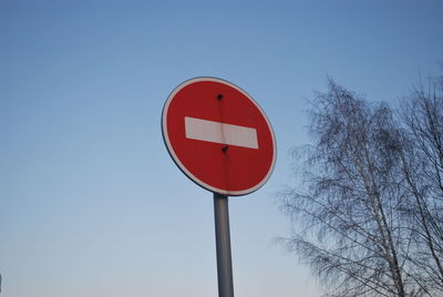 Low angle view of do not enter sign against clear sky