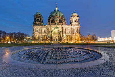 The illuminated berlin cathedral early in the morning
