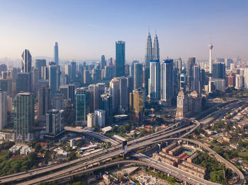 Aerial view of modern buildings in city against sky