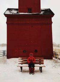 Person sitting on bench during winter