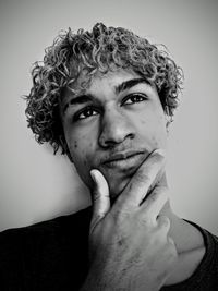 Portrait of young man against gray background