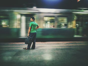 Full length of man standing at railroad station