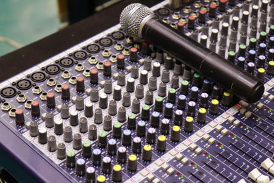 High angle view of microphone and sound mixer