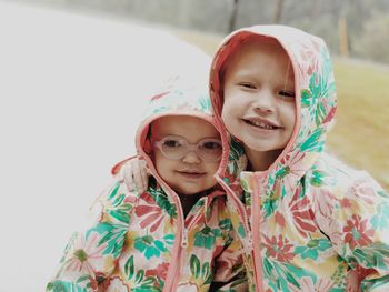 Close-up of siblings wearing raincoat