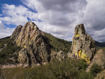 Rock formations on landscape against sky