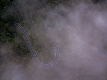 Aerial view of a road in the middle of the forest