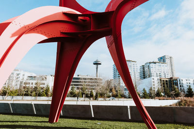 Buildings seen through bridge against sky