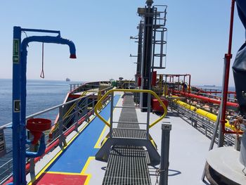 Metallic structure by sea against clear sky