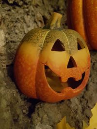 Close-up of pumpkin on stone wall during halloween