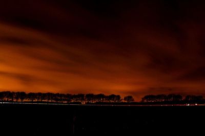 Scenic view of landscape against sky at dusk