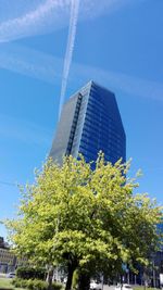 Low angle view of modern building against blue sky