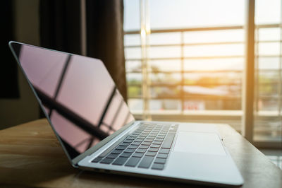 Close-up of laptop on table at home